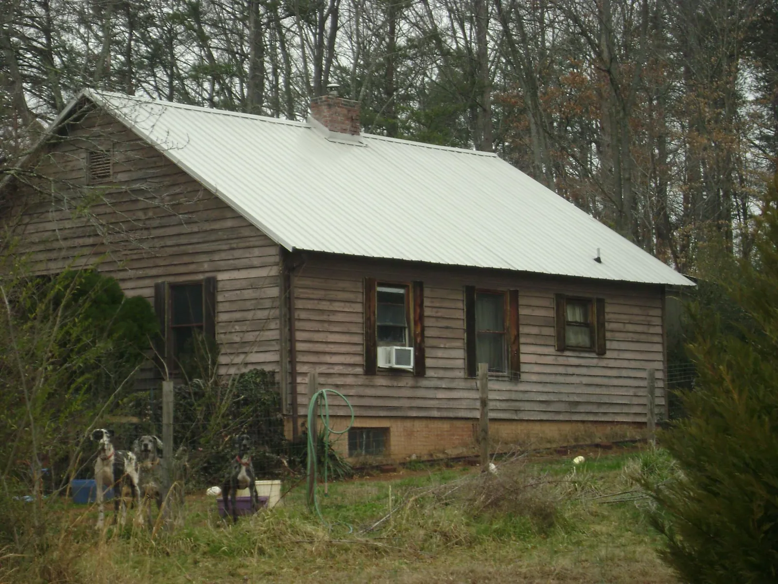 White metal roof on an old wood sided farmhouse, from a Metal Roof Installation job in Saint Joe